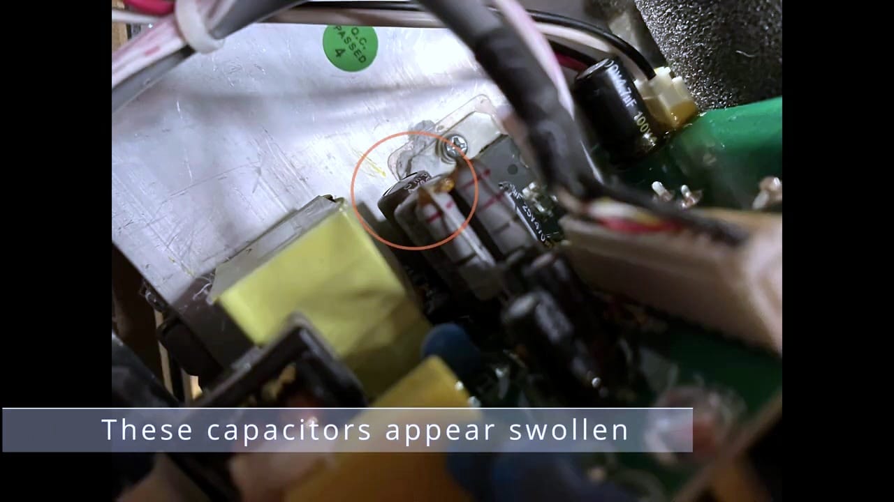 Close-up of two swollen 25 V 1000 uF capacitors
