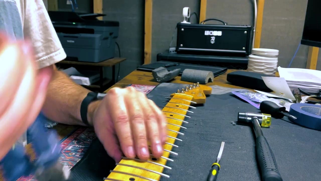 New fret ends sticking out past the fretboard