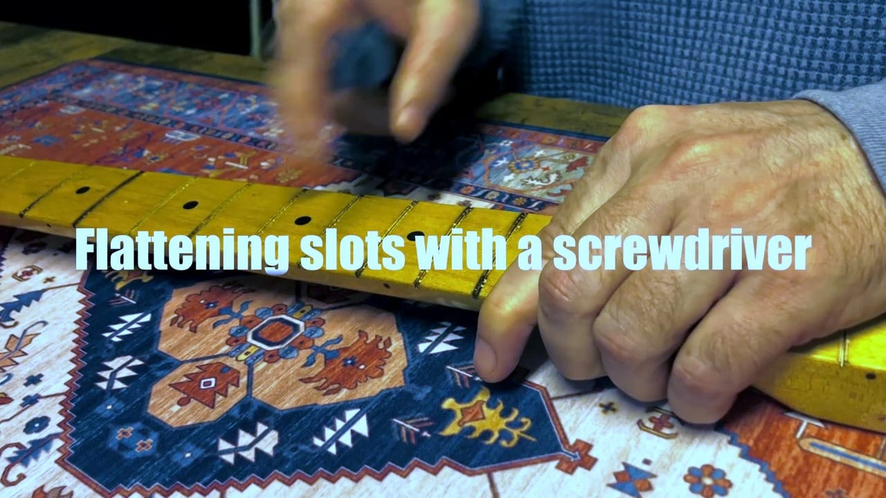 Flattening fret slot edges with a screwdriver